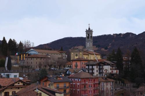 a town with a clock tower on a mountain at T'AMI Hotel Resort Spa in Selvino