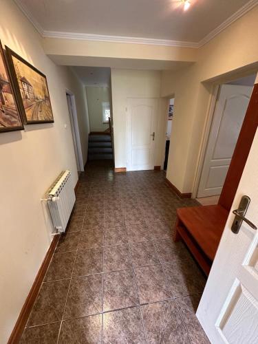 an empty hallway with a tile floor and a staircase at Willa Rudno Nad Jeziorem Parter in Rudno