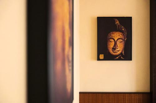 a picture of a mask hanging on a wall at T'AMI Hotel Resort Spa in Selvino