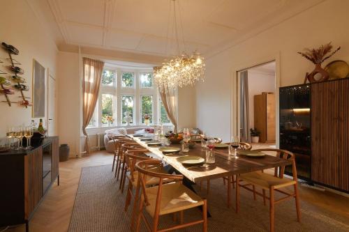 a dining room with a long table and chairs at Huge Royal Luxury Apt with Private Balcony in Copenhagen