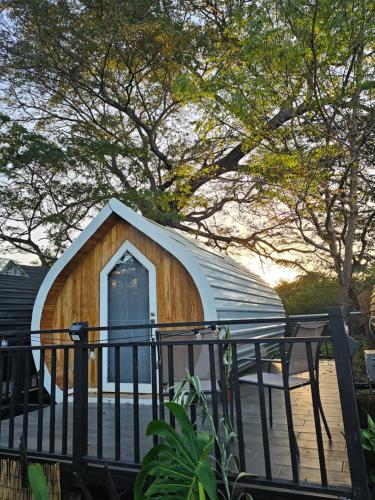 a small wooden building with a roof at Rincón del Mar Glamping in Potrero