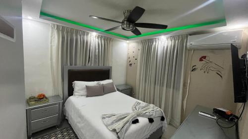 a bedroom with a bed with a ceiling fan at Apt Curiel II in El Cachón