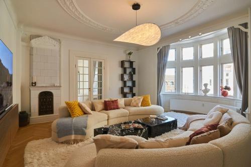 a living room with two couches and a fireplace at Huge Royal Luxury Apt with Private Balcony in Copenhagen