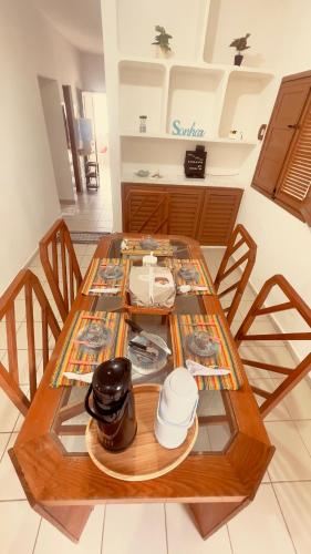 a dining room table with a glass top at Casa de Veraneio na Praia in Extremóz