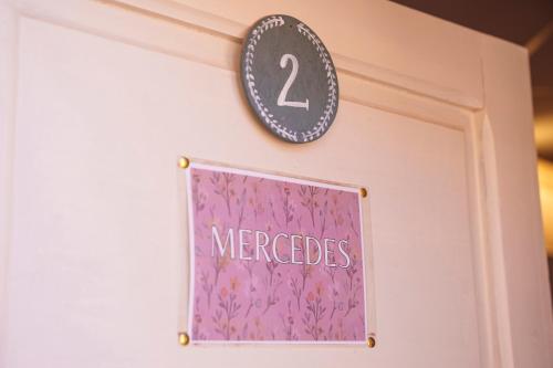 a door with a sign that reads mercedes at Mestiza Hostal in Humahuaca