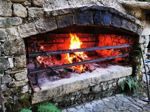 a brick oven with a fire in it at Agriturismo Tuluschene in Gavoi