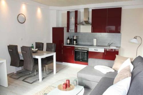 a kitchen and living room with a couch and a table at 4 Sterne Ferienwohnung Schlossblick Sauna Pool Whirlpool pri in Braunfels