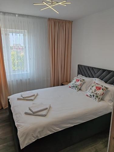 a bedroom with a bed with towels on it at Dani-Mihaela in Jurilovca