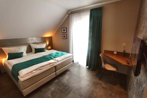 a bedroom with a bed and a desk and a window at Ferien_VILLA EASY LIVING in Göhren-Lebbin