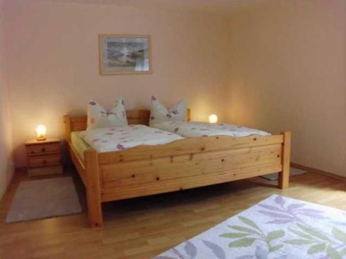 two beds in a bedroom with two candles on them at Besch, Antje in Ueckeritz