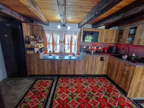a kitchen with a rug in the middle of a room at Vintage House in Elena