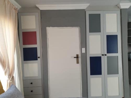 a room with a door with blue and white paint at Cuse guest house in Polokwane