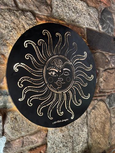 a black plate with a sun painted on it at Agriturismo Tuluschene in Gavoi