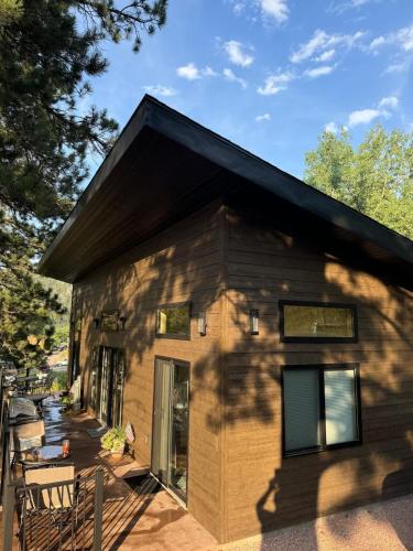 a small house with a shadow of a tree at In the center of it all The Elkhorn Cabin in Keystone