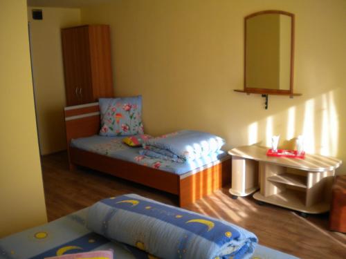 a small room with a bed and a table at Motel Dalia in Gilău