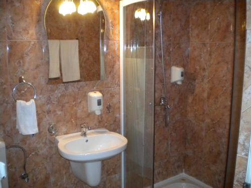 a bathroom with a sink and a shower at Motel Dalia in Gilău