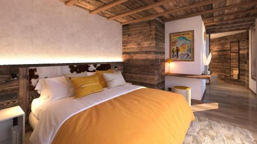 una camera con un grande letto e pareti in legno di Chalet TaÏga - Chalet d'exception au coeur des 3 Vallées MAE-2203 a Saint-Martin-de-Belleville
