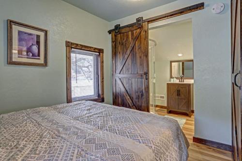 a bedroom with a bed and a sliding barn door at Grandma Goodnight's just 3 Miles from Mt-Rushmore in Keystone