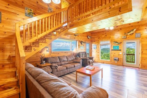 a living room with a couch and a staircase at Fish Tales Cabin with a private hot tub in Bryant