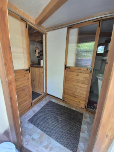 a small room with two doors and a floor at Art Apartments Minic in Kolašin