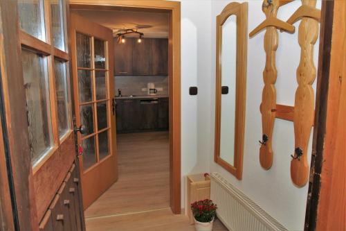 a hallway leading to a kitchen with wooden cabinets at Bocksleitnerhof in Wackersberg