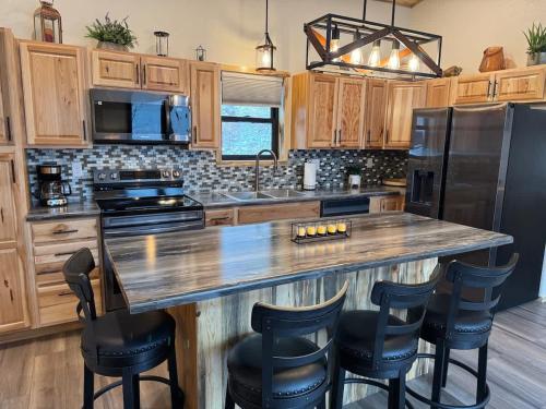 a kitchen with a large island with bar stools at The Bonnie View in Keystone