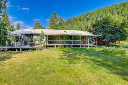 a house with a large yard in front of a forest at Hiking, Hunting and Skiing Serene Sula Cabin in Sula