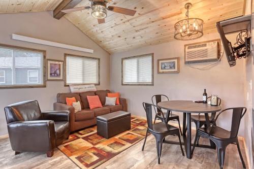 a living room with a couch and a table and chairs at Rustic getaway in the woods in Keystone