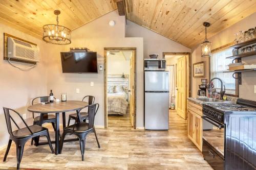 a kitchen and dining room with a table and chairs at Rustic getaway in the woods in Keystone