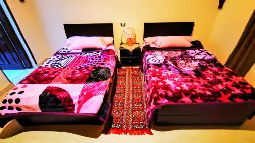 two beds sitting next to each other in a bedroom at Egypt Soul hotel retreat in Luxor