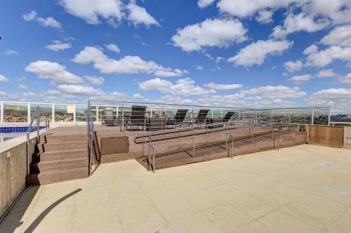 a balcony with chairs and stairs on a building at Allia Gran Pampulha Suites in Belo Horizonte