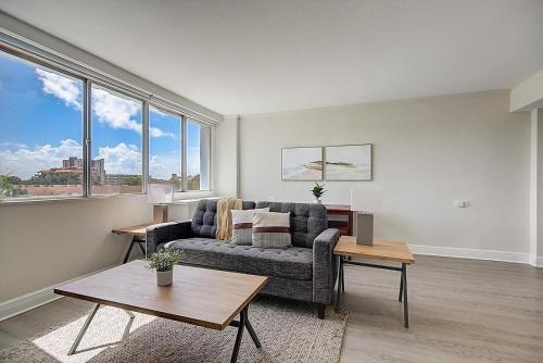 a living room with a couch and a table at Landing Stunning Studio Gym Clubhouse in St. Petersburg