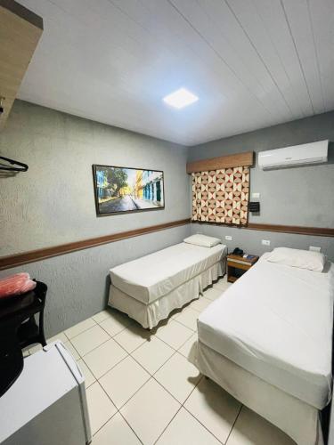 a hotel room with two beds in a room at Inter Hotel in Recife