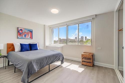 a bedroom with a bed and a large window at Landing Apartments - St Petersburg in St Petersburg