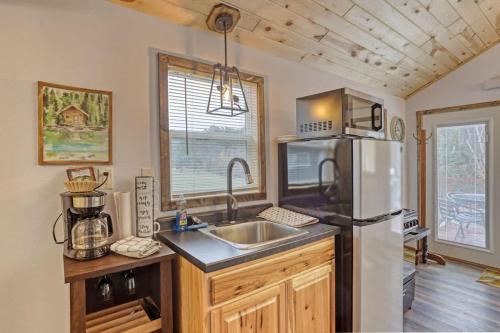 a kitchen with a sink and a refrigerator at Cozy Creekside Retreat in Keystone