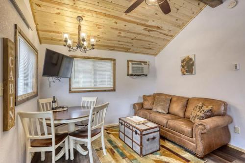 a living room with a couch and a table at Cozy Creekside Retreat in Keystone