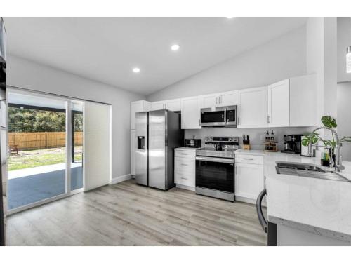 a kitchen with white cabinets and stainless steel appliances at Rainbow Springs Paradise in Dunnellon