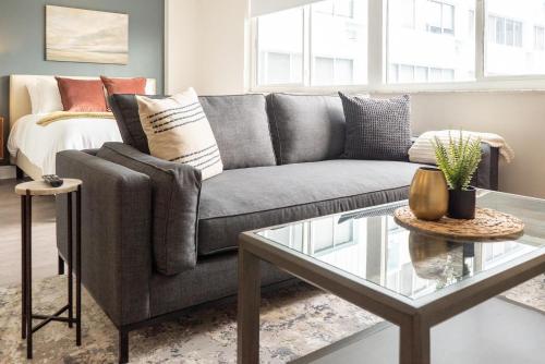 a living room with a couch and a glass table at Landing Stunning Studio Gym Clubhouse in St. Petersburg