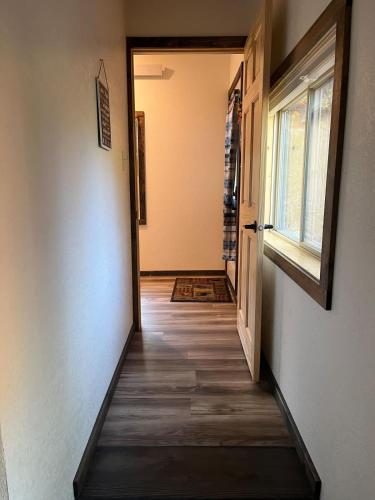an empty hallway with a door and a window at Bullion Street Hideaway in Keystone