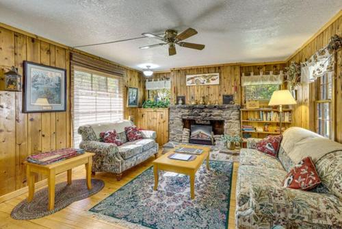 a living room with a couch and a fireplace at Grizzly Gulch Cabin Historic in Keystone