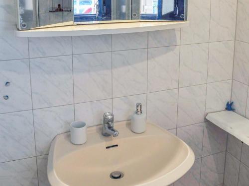 a bathroom sink with two rolls of toilet paper on it at Ferien auf dem Lande in Tribohm
