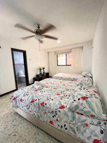 a bedroom with a bed and a ceiling fan at Baranoa House in Barranquilla