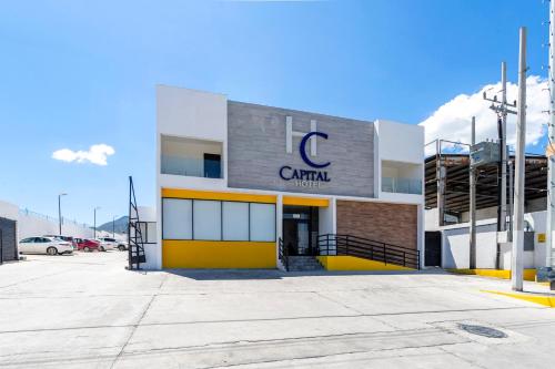 a building with a c car rental sign on it at Capital Hotel Saltillo in Saltillo