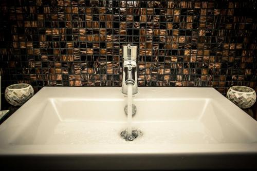 a sink with a faucet in a bathroom at Chalet Sch l afbock in Priesteblich