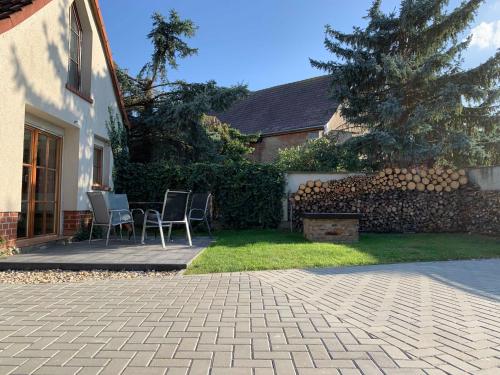 a patio with chairs and a fence and a tree at Chalet Sch l afbock in Priesteblich