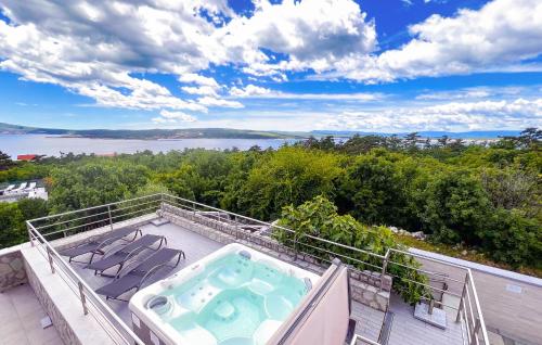 a hot tub on the balcony of a house at Amazing Home In Crikvenica With Wifi in Crikvenica