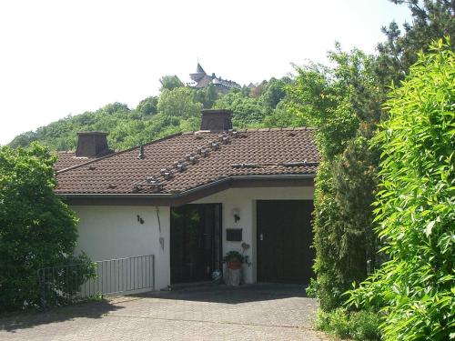a house with a brown roof and a garage at Ferienwohnung Burgblick in Waldeck