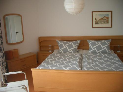 a bedroom with a bed and a mirror at Ferienwohnung Burgblick in Waldeck