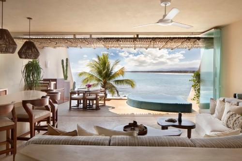 a living room with a view of the ocean at Punta Majahua by PRC Hospitality in La Majahua