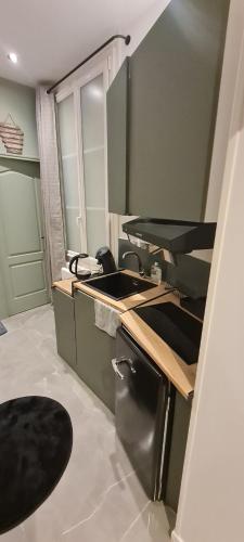 a kitchen with a sink and a counter top at Apartment in Paris with Jaccuzzi in Paris